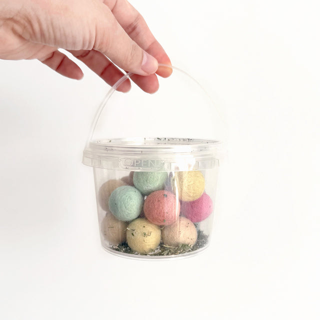 catnip felt ball in a clear bucket
